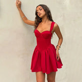 Woman wearing a red dress against a plain background